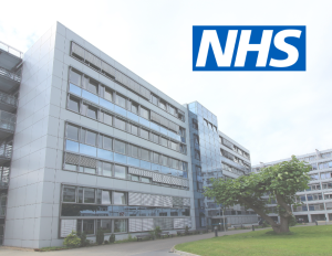 Photo of a hospital with the NHS logo